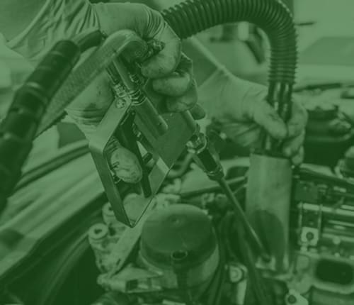 green image of technician performing DPF cleaning
